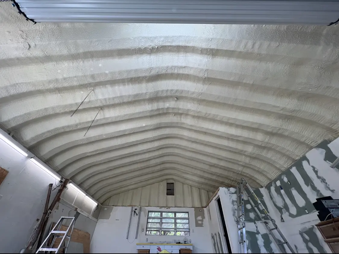 Spray polyurethane foam applied to the underside of a metal roof deck in Kodiak